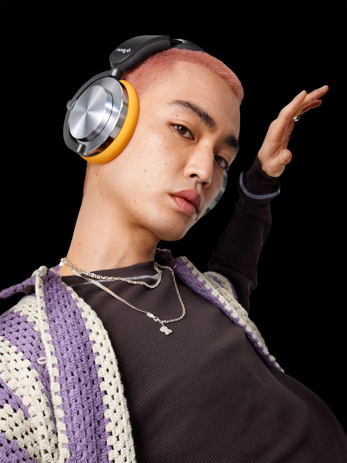 Person wearing large headphones with a black background
