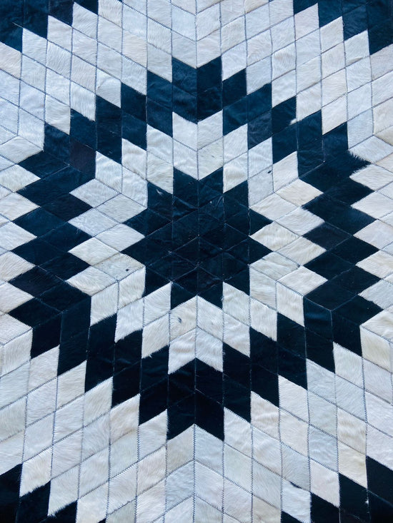 Geometric patterned rug with black and white diamond shapes