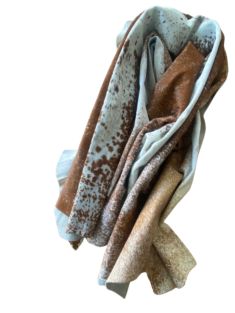 Folded brown, beige, and white COW HIDE
