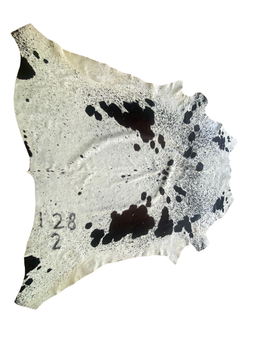 Cowhide with black spots on a white background
