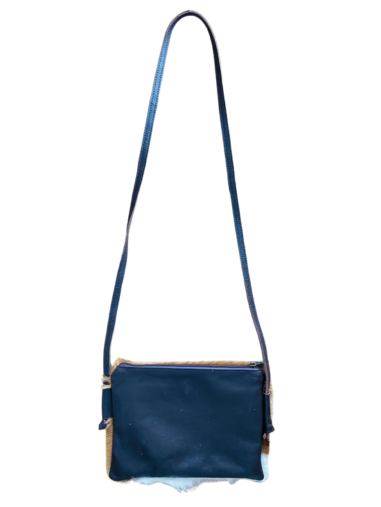 Blue leather crossbody bag with a strap on a white background