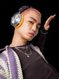 Person wearing large headphones with a black background