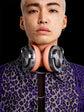 Person wearing a pair of headphones with a black background