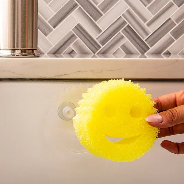 Daddy Caddy holding a Scrub Daddy sponge mounted on a kitchen surface