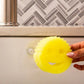 Daddy Caddy holding a Scrub Daddy sponge mounted on a kitchen surface