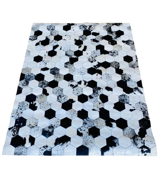 Hexagonal patterned rug with black, white, and grey colours 