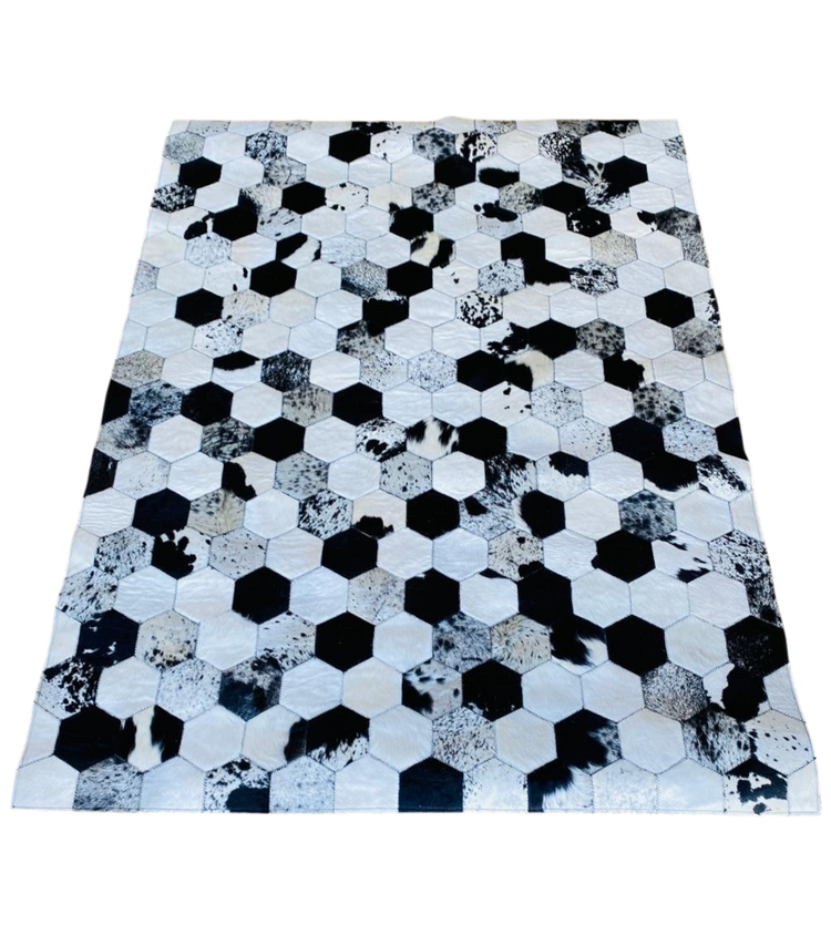 Hexagonal patterned rug with black, white, and grey colours 