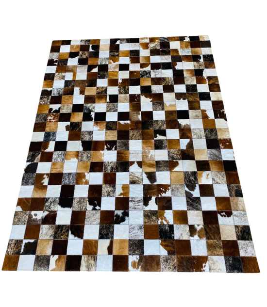 square patterned rug with brown, black, and white patches 