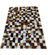 square patterned rug with brown, black, and white patches 
