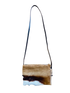 Crossbody bag with a natural cowhide pattern on a white background