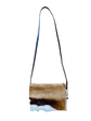 Crossbody bag with a natural cowhide pattern on a white background