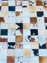 Patchwork of cowhide patterns in a grid layout